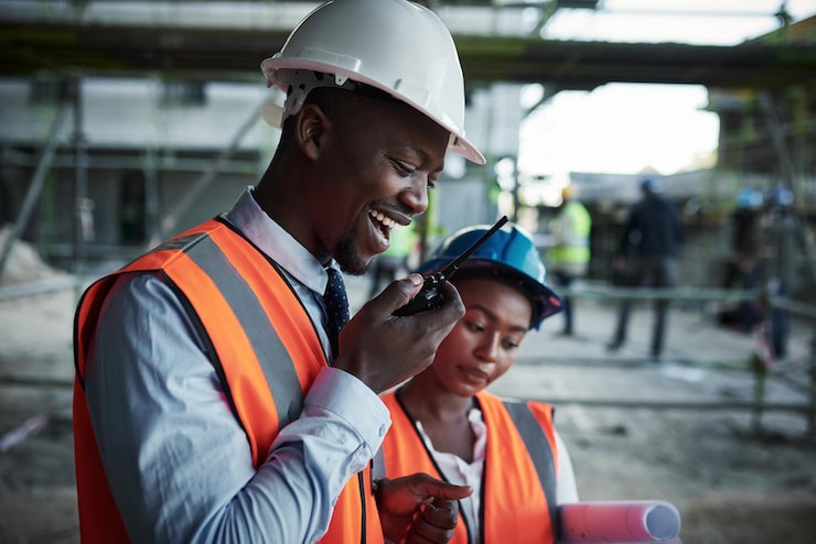 quality-construction-inspired-by-teamwork-shot-young-man-using-walkie-talkie-while-working-with-his-colleague-construction-site_590464-29629